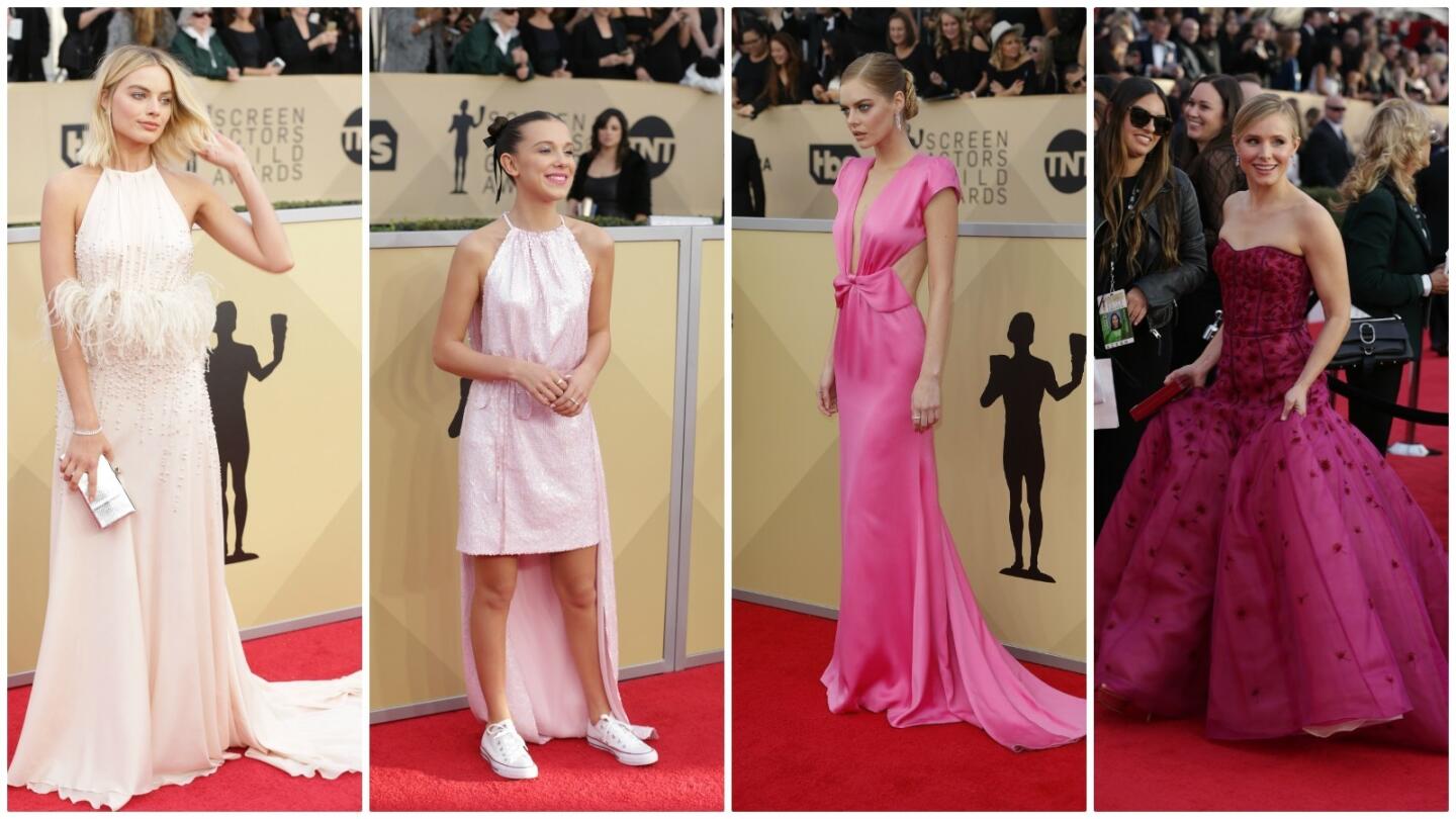 The parade of pink at the 24th annual SAG Awards included, from left, Margot Robbie in a pastel pink silk crepe chiffon Miu Miu gown with ostrich feather empire waist detail; Millie Bobby Brown in a pre-spring 2018 rose sequined Calvin Klein cocktail dress with gathered neckline, fitted waist and high-low hem; Samara Weaving in a fuchsia Miu Miu gown with gathered draped bow and deep neckline detail and host Kirsten Bell in a fuchsia J. Mendel gown.