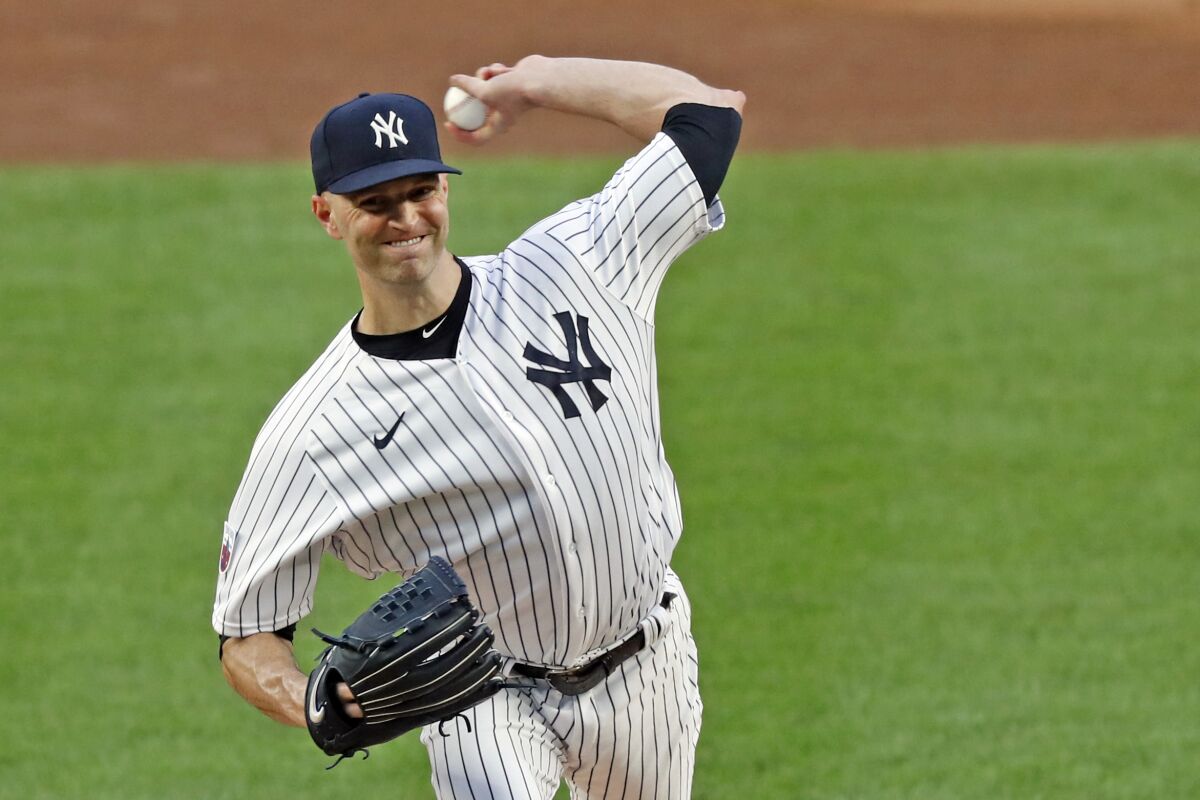 New York Yankees starting pitcher J.A. Happ winds up during the first inning of a baseball game against the Boston Red Sox, Sunday, Aug. 16, 2020, in New York. (AP Photo/Kathy Willens)