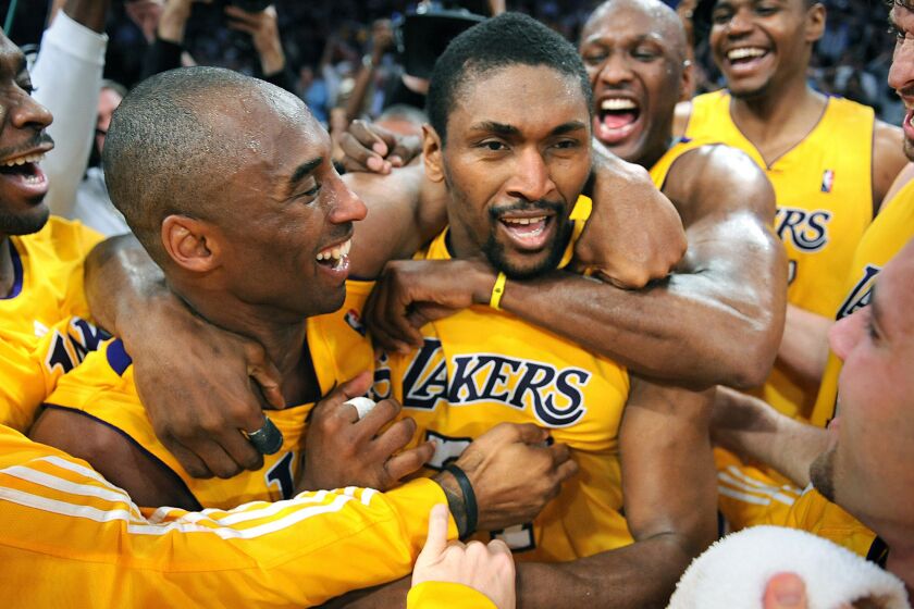 Lakers forward Ron Artest, center, is congratulated by Kobe Bryant, left, and the rest of his teammates after hitting the winning shot against the Phoenix Suns in Game 5 of the 2010 Western Conference finals.
