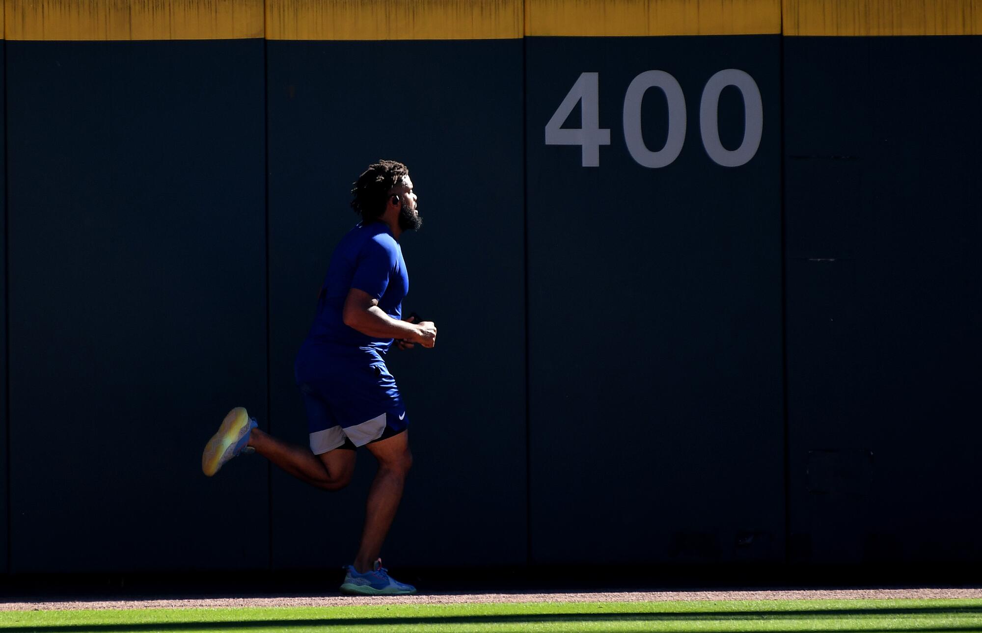 The Dodgers' Kenley Jansen runs in the outfield to warm up before Game 1.