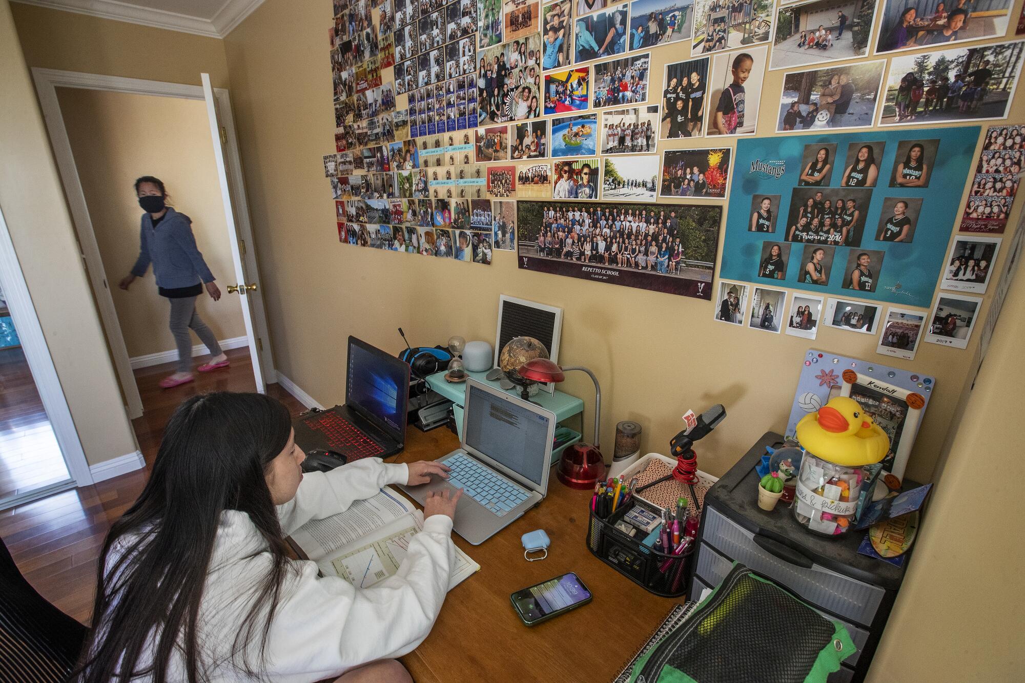 Kendall Tam works at a computer at her home in Monterey Park.