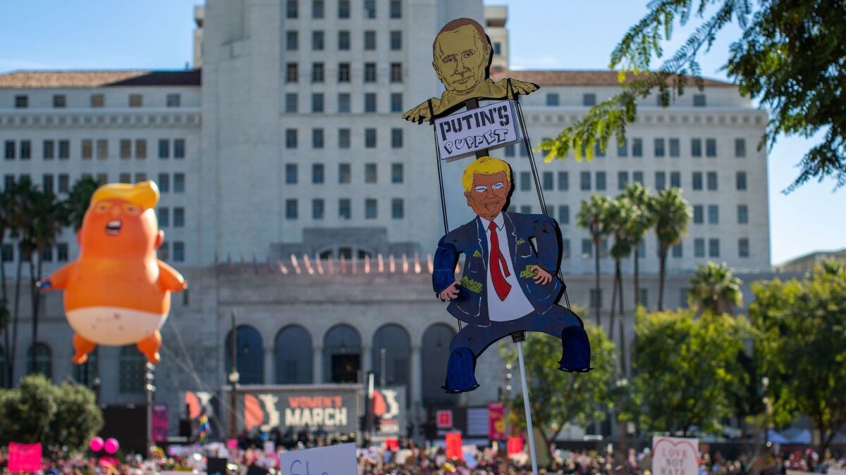 Signs and props mocking President Trump were prominent during the Women's March in downtown Los Angeles on Jan. 19.
