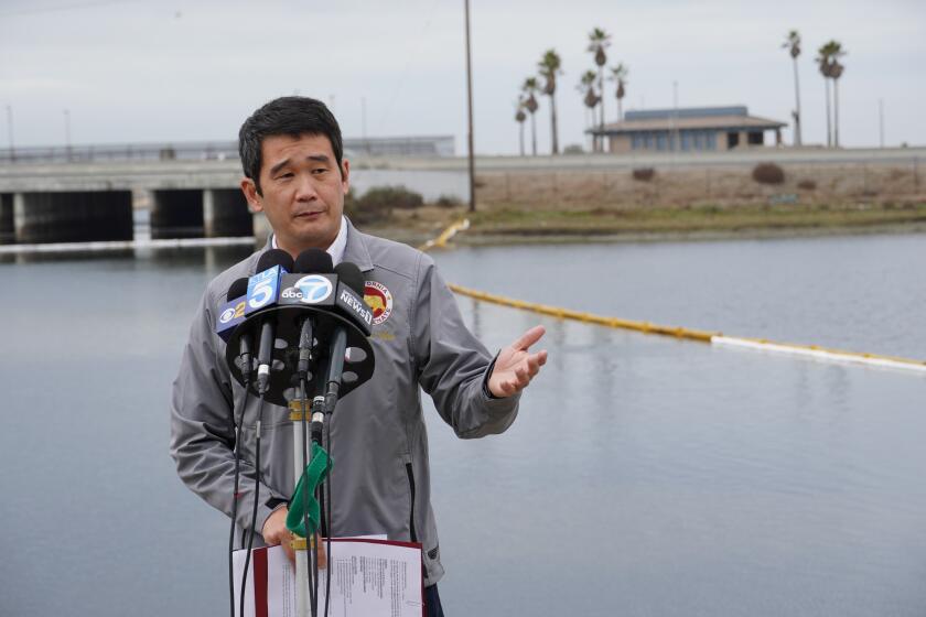 State Sen. Dave Min, D-Dist. 37, talks to the media after touring the cleaning efforts at the Talbert Marsh in Huntington Beach, Calif., Wednesday, Oct. 6, 2021. An oil spill sent up to 126,000 gallons of heavy crude into the ocean. It contaminated the sands of famed Huntington Beach and other coastal communities. (AP Photo/Eugene Garcia)