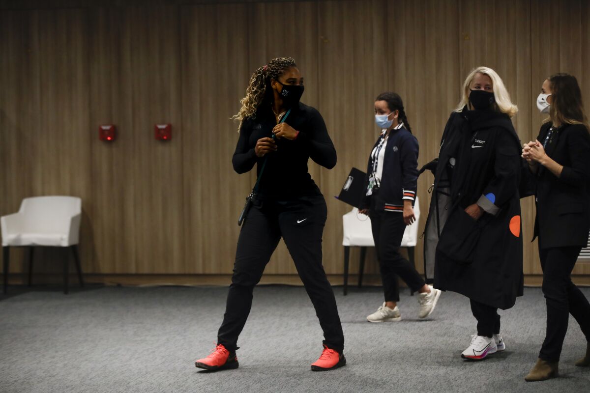 Tennis star Serena Williams leaves a news conference in Paris.