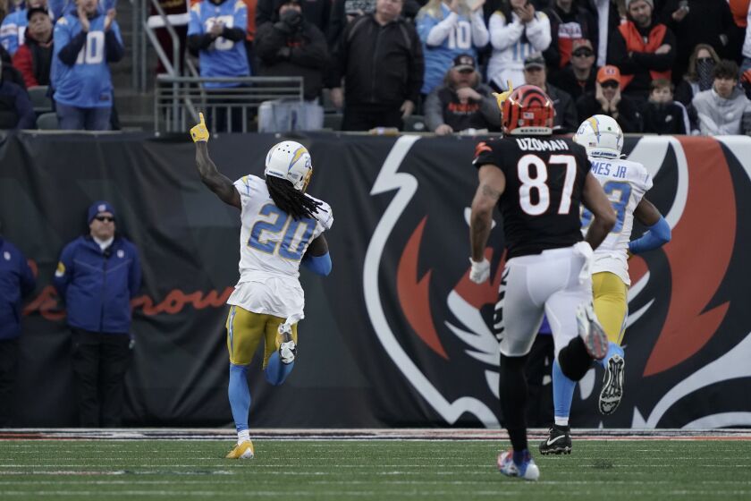 Los Angeles Chargers' Tevaughn Campbell (20) celebrates a fumble recovery for a touchdown during the second half of an NFL football game against the Cincinnati Bengals, Sunday, Dec. 5, 2021, in Cincinnati. (AP Photo/Jeff Dean)