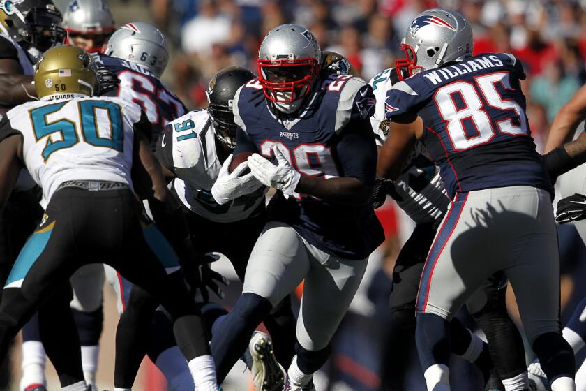 New England Patriots running back LeGarrette Blount runs through Jacksonville Jaguars defenders on Sept. 27.