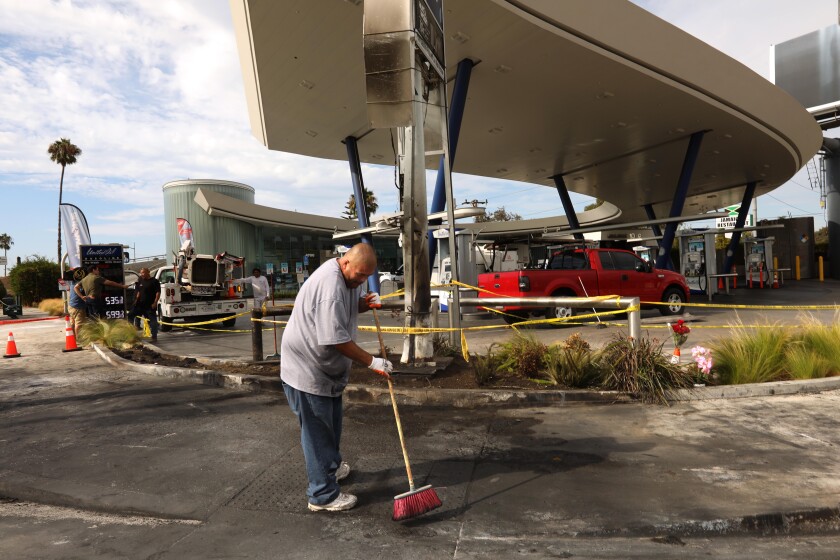 A worker cleans up the scene of the accident