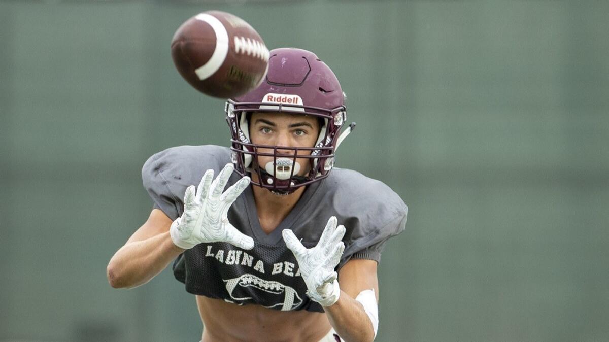 Wide receiver Kai Ball catches a pass during Laguna Beach High's practice on Aug. 15.