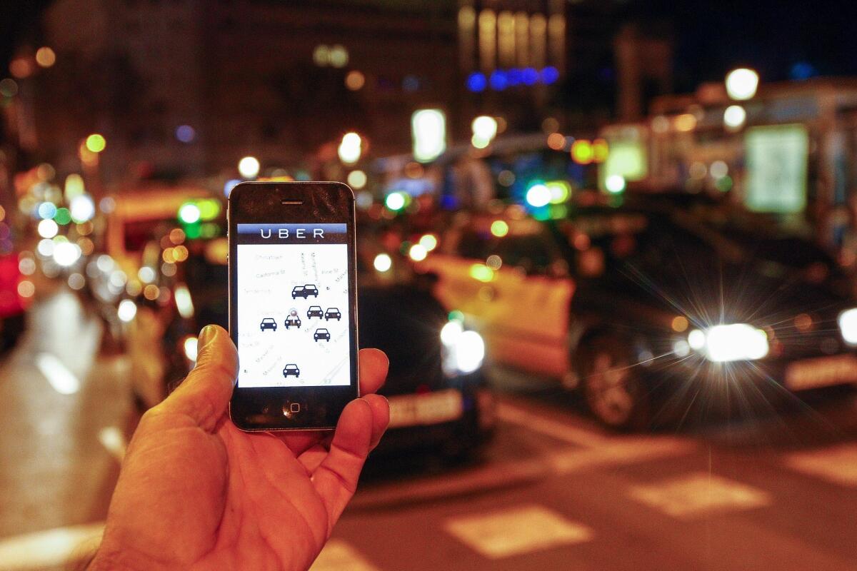 The Uber app is seen on a smartphone in Barcelona, Spain, on Dec. 9.