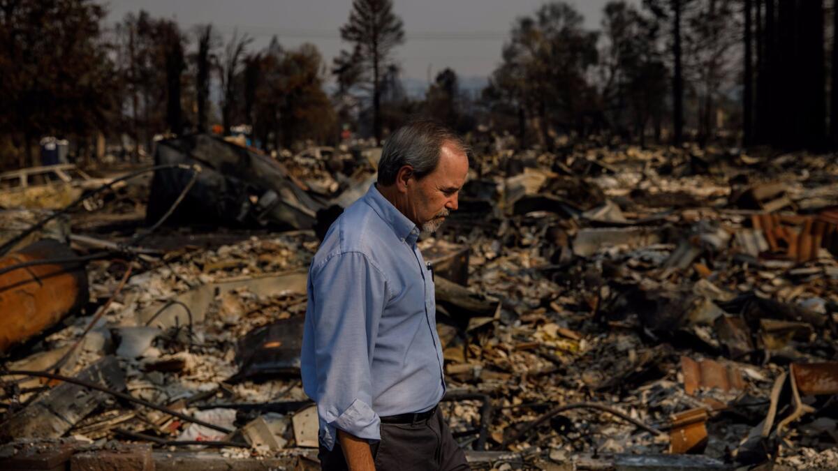 Santa Rosa Mayor Chris Coursey walks through the Coffey Park neighborhood of his city, which was completely leveled by fire at the beginning of the week.