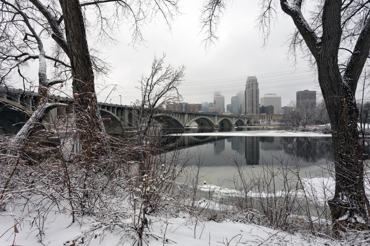 Minneapolis seen across the Mississippi river with snow and ice in January.
