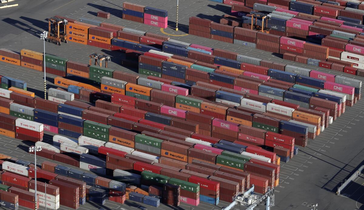 Cargo containers wait near cranes at the Port of Tacoma in Washington. Washington said tariffs on many products from China would go up from 10% to 25%.