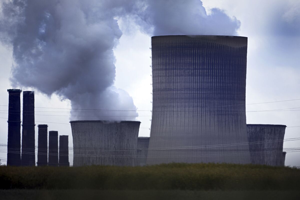 Steam rises out of the cooling towers of the Niederaussem lignite-fired power plant in Pulheim, Germany, Monday, June 20, 2022. The German government said that it remains committed to its goal of phasing out coal as a power source by 2030 despite deepening worries about a cut in Russia’s gas supplies. (Federico Gambarini/dpa via AP)