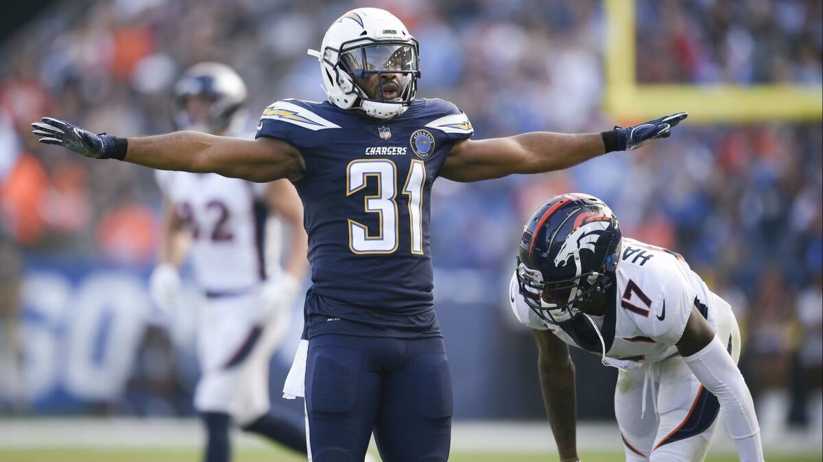 Chargers safety Adrian Phillips, left, celebrates after breaking up a pass intended for Denver wide receiver DaeSean Hamilton on Nov. 18.