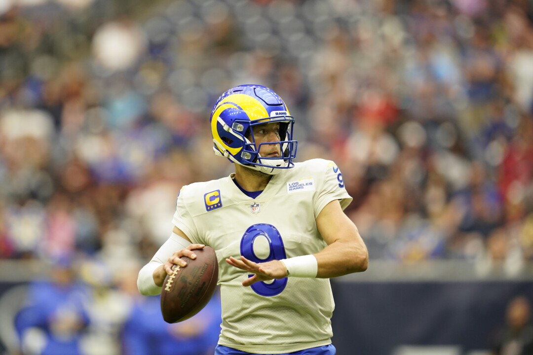 Rams quarterback Matthew Stafford rolls out as he looks to pass.