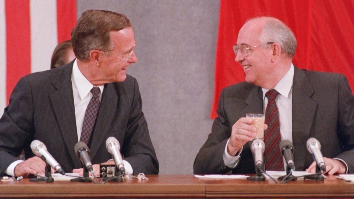 President George H.W. Bush and his Soviet counterpart Mikhail Gorbachev laugh during a joint news conference in Moscow on July 31, 1991.