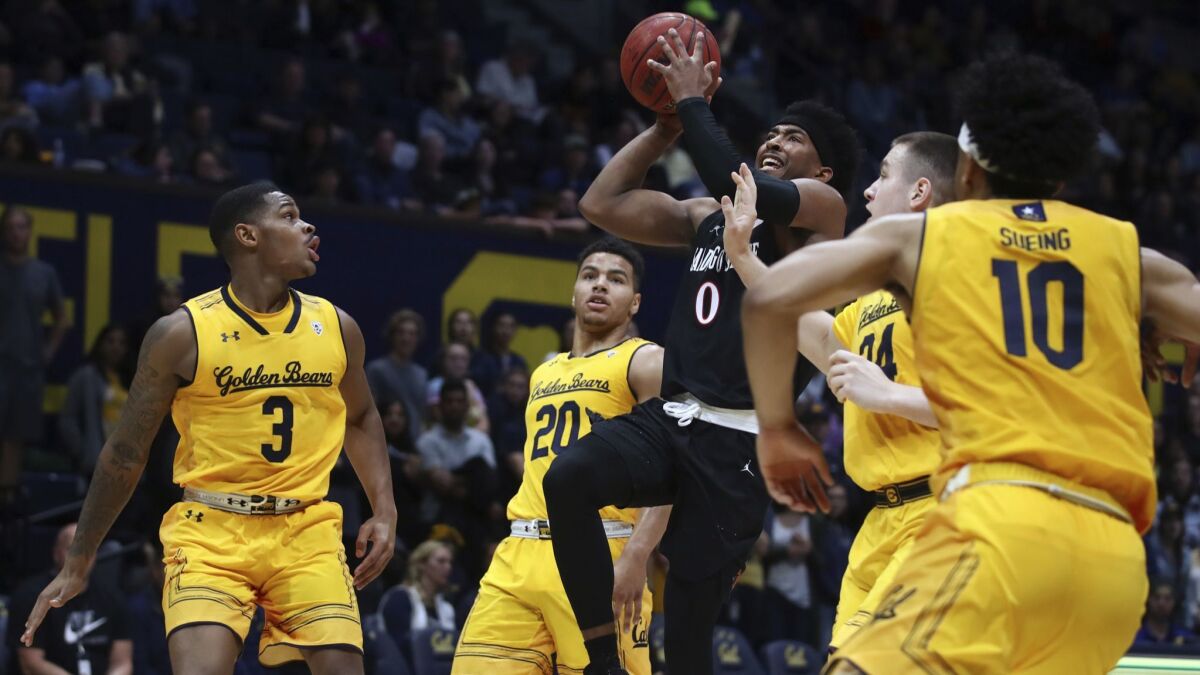 San Diego's Devin Watson (0) shoots against California's Paris Austin (3), Matt Bradley (20), Grant Anticevich (34) and Justice Sueing (10) in the first half.