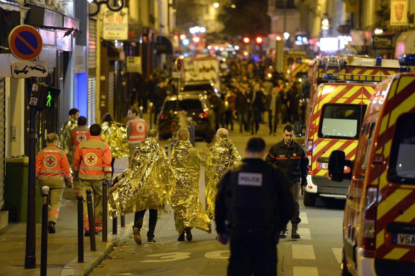 People are evacuated near the Bataclan concert hall early on Nov. 14, 2015, after an attack at the Parisian concert hall.