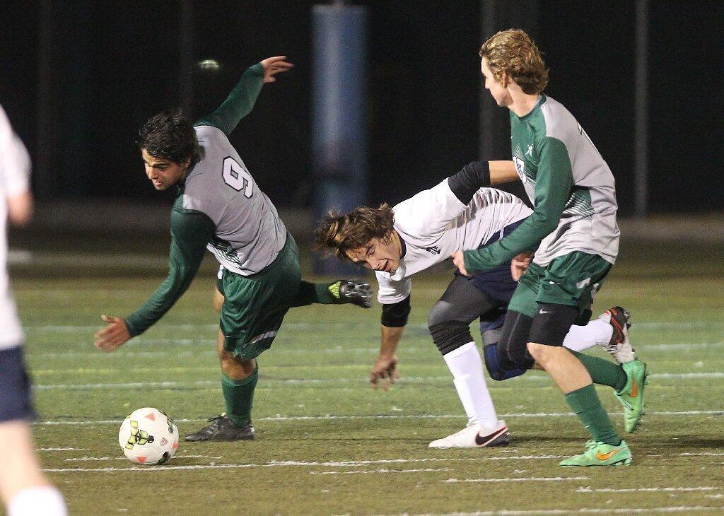 Sage Hill School's Gabe Gamboa (9) and teammate Josh Lee, right, disrupt a St. Margaret's player.