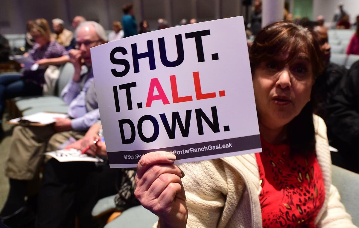 Sheryl Goldfarb, who said she has lived in Porter Ranch for 27 years, holds a placard expressing her feelings at a town hall meeting about the gas leak at Shepard of the Hills Church on Friday.