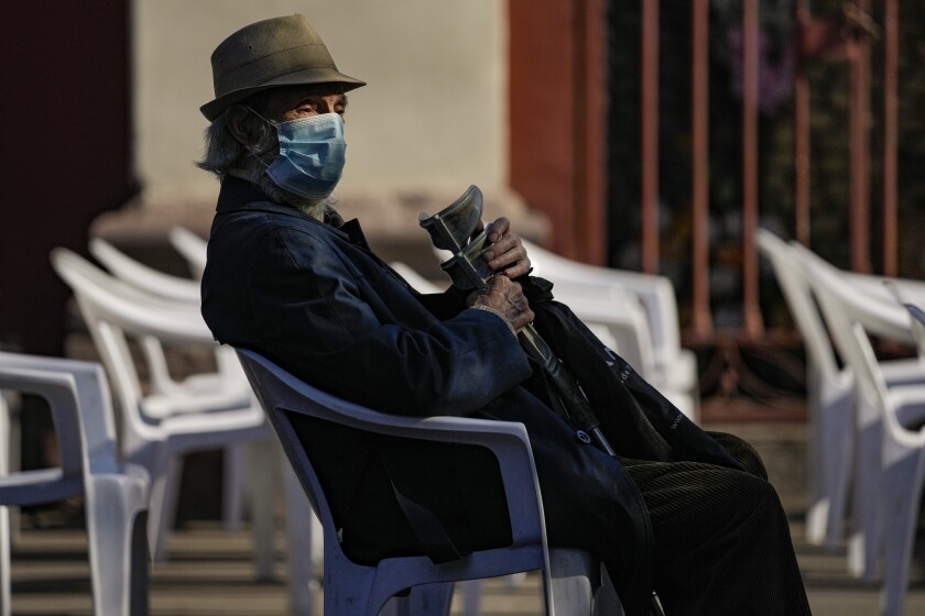 Luis Urrutia, an 84-year-old retired doctor, waits for his fourth COVID-19 vaccine shot, of AstraZeneca, at the start of a fourth shot booster shot campaign in Santiago, Chile, Monday, Jan. 10, 2022. (AP Photo/Esteban Felix)