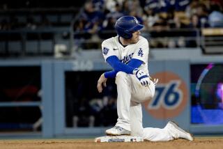LOS ANGELES, CA - APRIL 1, 2024: Los Angeles Dodgers first baseman Freddie Freeman (5) kneels at second base during a play review after hitting an RBI double against the San Francisco Giants in the seventh inning at Dodger Stadium on April 1, 2024 in Los Angeles, California. (Gina Ferazzi / Los Angeles Times)