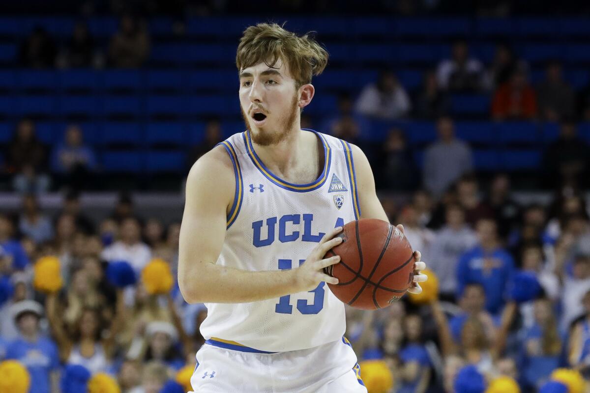 UCLA guard Jake Kyman looks to pass against Stanford.