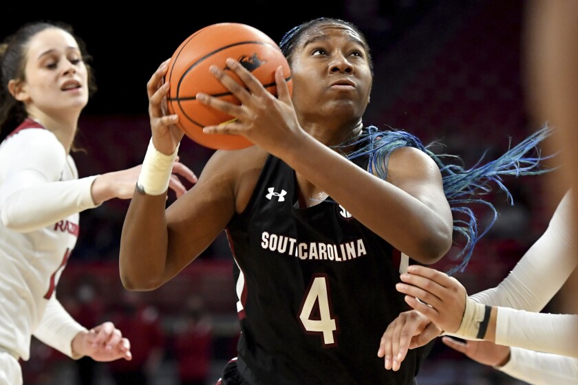 South Carolina forward Aliyah Boston (4) tries to get past Arkansas guard Sasha Goforth, left, during the second half of an NCAA college basketball game Sunday, Jan. 16, 2022, in Fayetteville, Ark. (AP Photo/Michael Woods)
