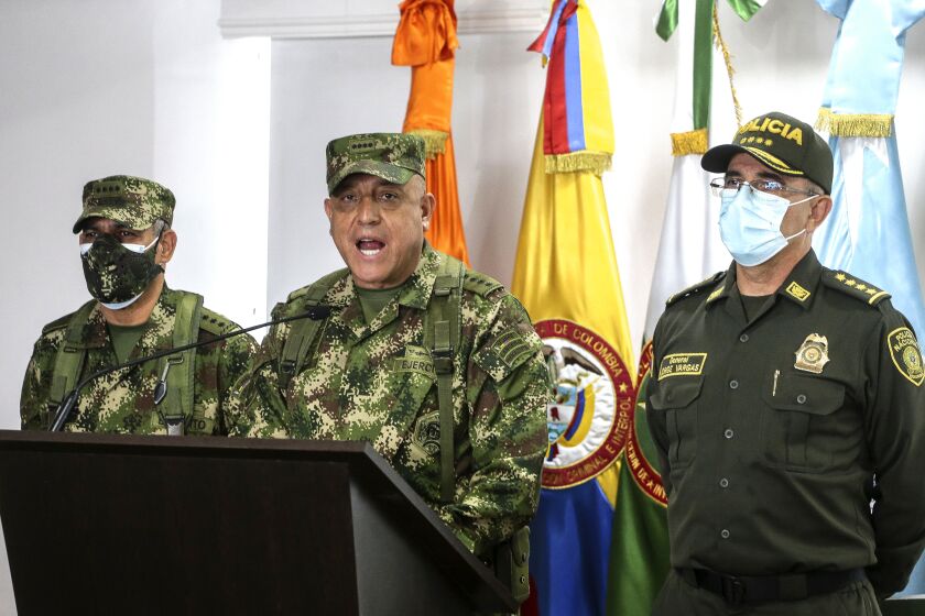 Colombian Armed Forces Commander Gen. Luis Fernando Navarro, center, National Police Director Gen. Jorge Luis Vargas, right, and Army Commander Gen. Eduardo Zapateriro give a press conference regarding the alleged participation of former Colombian soldiers in the assassination of Haiti's President Jovenel Moïse, in Bogota, Colombia, Friday, July 9, 2021. (AP Photo/Ivan Valencia)