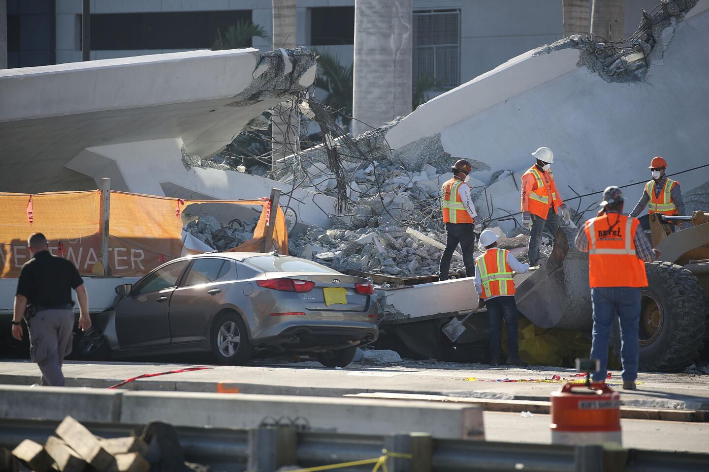 MIAMI, FL - MARCH 16: Workers, law enforcement and members of the National Transportation Safety Board investigate the scene where a pedestrian bridge collapsed a few days after it was built over southwest 8th street allowing people to bypass the busy street to reach Florida International University on March 16, 2018 in Miami, Florida. Reports indicate that there are six fatalities as a result of the collapse.