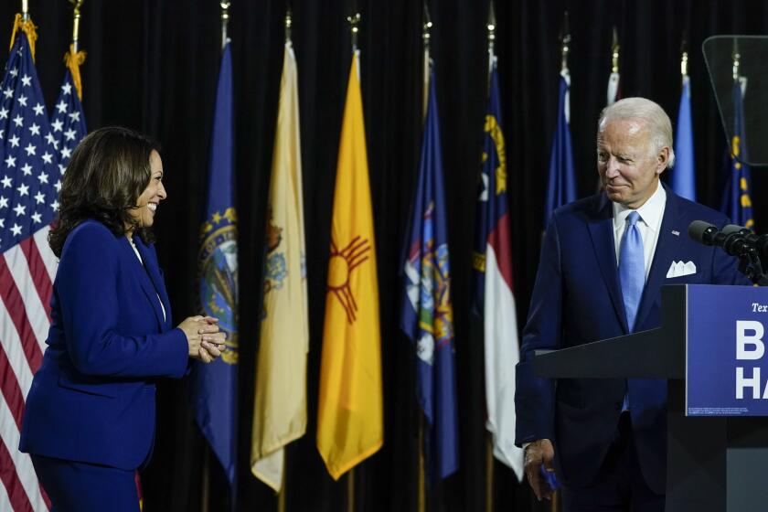 WILMINGTON, DE - AUGUST 12: Presumptive Democratic presidential nominee former Vice President Joe Biden invites his running mate Sen. Kamala Harris (D-CA) to the stage to deliver remarks at the Alexis Dupont High School on August 12, 2020 in Wilmington, Delaware. Harris is the first Black woman and first person of Indian descent to be a presumptive nominee on a presidential ticket by a major party in U.S. history. (Photo by Drew Angerer/Getty Images)