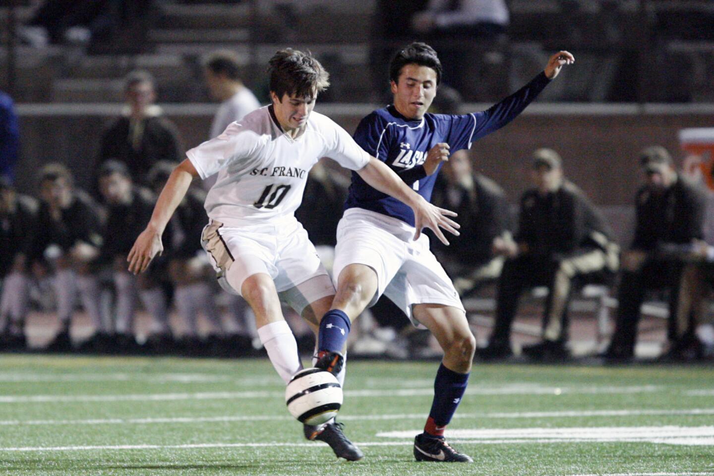 St. Francis' Brookes Treidler, left, and La Salle's Branden Sandoval fight for the ball during a game at St. Francis High School in La Canada on Tuesday, November 27, 2012.