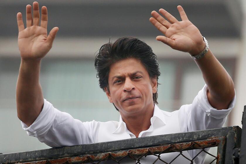 Bollywood actor Shah Rukh Khan greets fans waiting outside his residence in Mumbai, India, earlier this year.