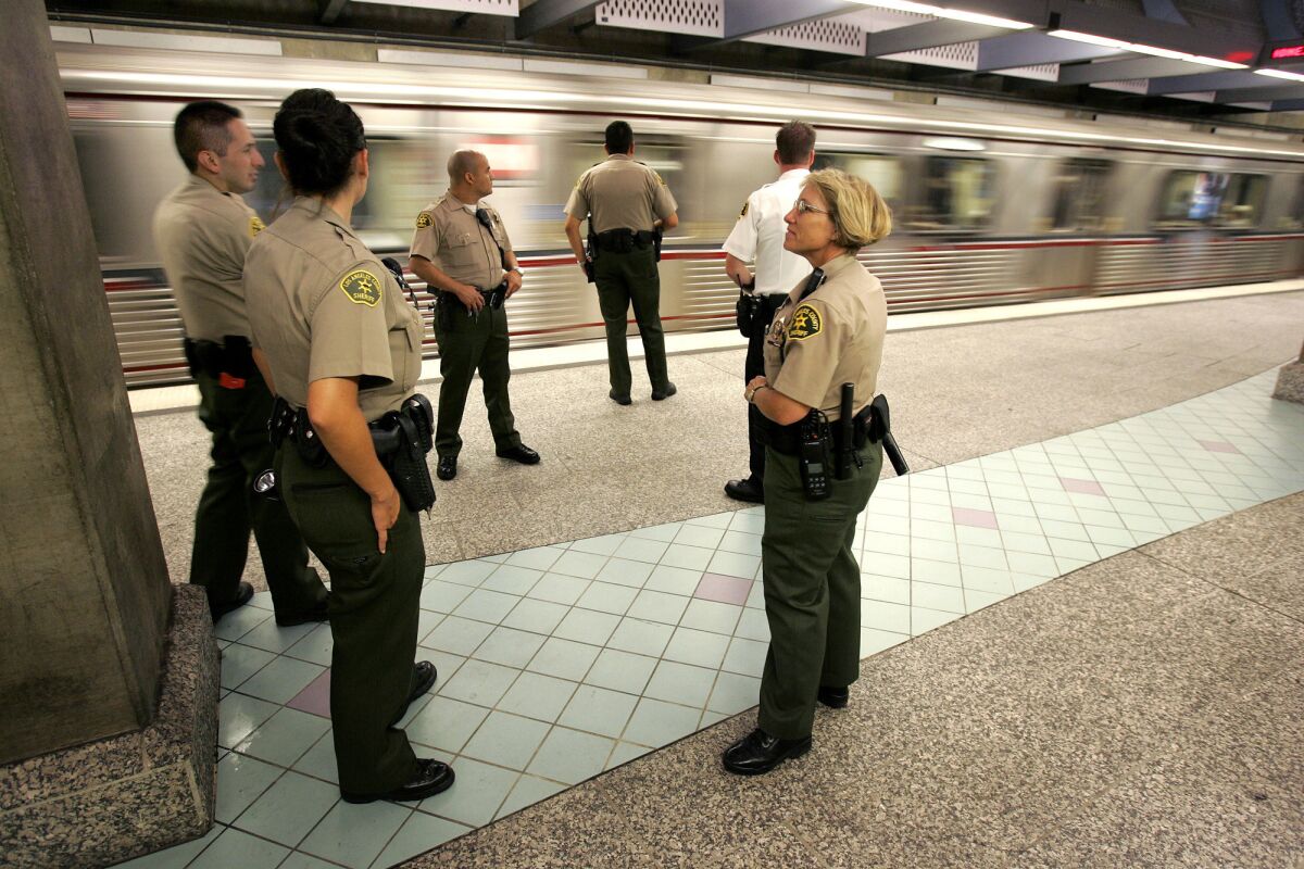 Sheriff's deputies staff the platform of the Hollywood-Highland Metro Red Line station. A new Metro hotline, staffed by counselors, will connect riders who have been harassed with professional assistance.