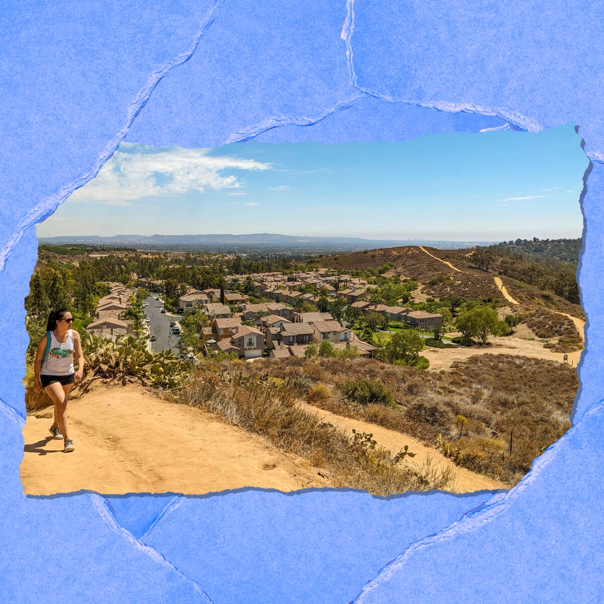 A woman hiking with a view of the horizon behind her.