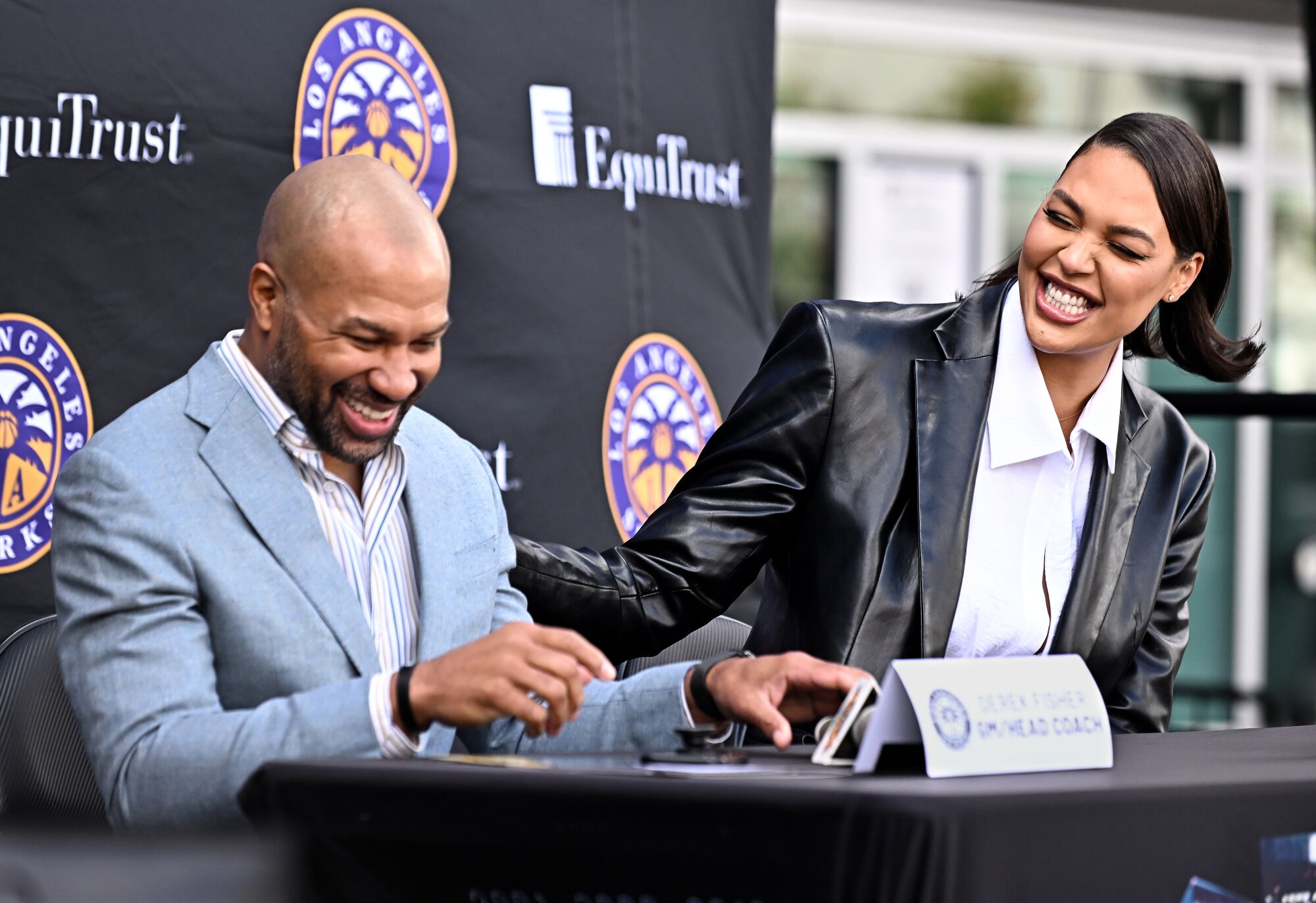 Liz Cambage and Sparks coach Derek Fisher share a laugh during her introductory news conference.