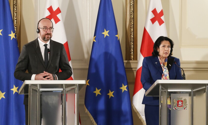In this photo provided by the Georgian Presidential Press Office, Georgia's President Salome Zurabishvili, right, speaks during a joint news briefing with European Council President Charles Michel in Tbilisi, Georgia, Monday, March 1, 2021 (Georgian Presidential Press Office via AP)