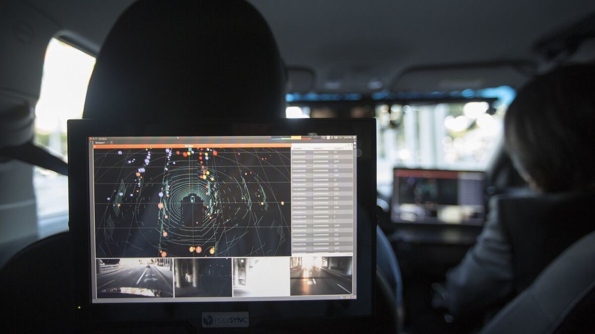 Data from lidar, radar, cameras and GPS units are displayed inside a car equipped with a PolySync driverless-technology monitoring system during the AutoMobility LA trade show at the Los Angeles Convention Center in 2016.