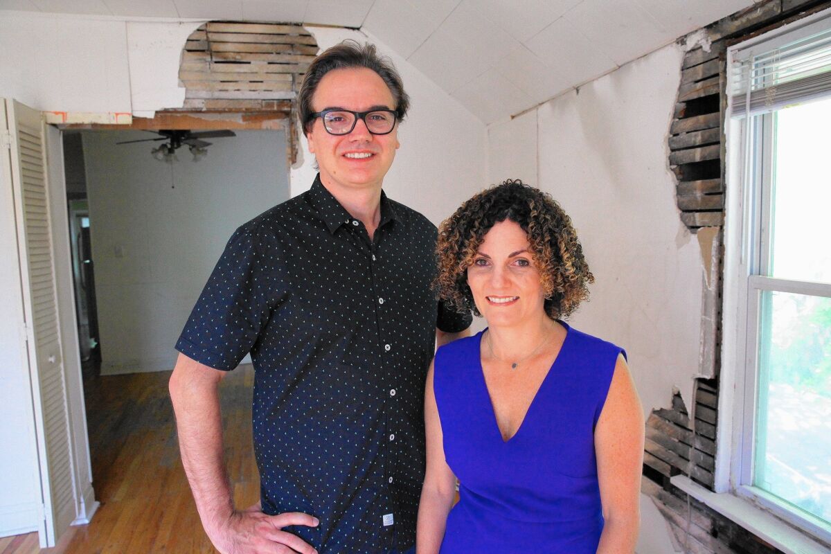 Brent Young and Dina Benadon inside Walt Disney's birthplace in a working-class Chicago neighborhood. The owners aim to open a multimedia museum showing what life was like for the Disneys in the early 20th century.
