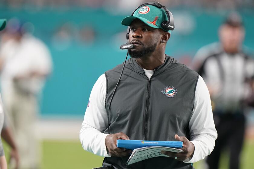 Miami Dolphins head coach Brian Flores stands on the sideline during the second half of an NFL football game against the New England Patriots, Sunday, Jan. 9, 2022, in Miami Gardens, Fla. (AP Photo/Wilfredo Lee)