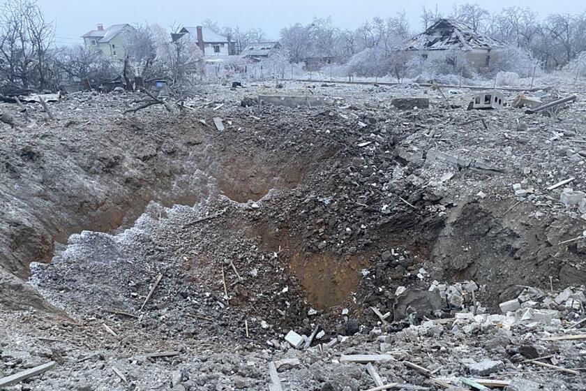 FILE - In this photo provided by the Ukrainian Emergency Service, a crater of an explosion is seen next to the private building destroyed after a Russian missile attack in Novomoskovsk, near Kryvyi Rih, Ukraine, Monday, Jan. 8, 2024. Russia’s recent escalation of missile and drone attacks is stretching Ukraine’s air defense resources, a Ukrainian air force official said Tuesday, Jan. 9, 2024, leaving the country vulnerable in the 22-month war unless it can secure further weapons supplies. (Ukrainian Emergency Service via AP, File)