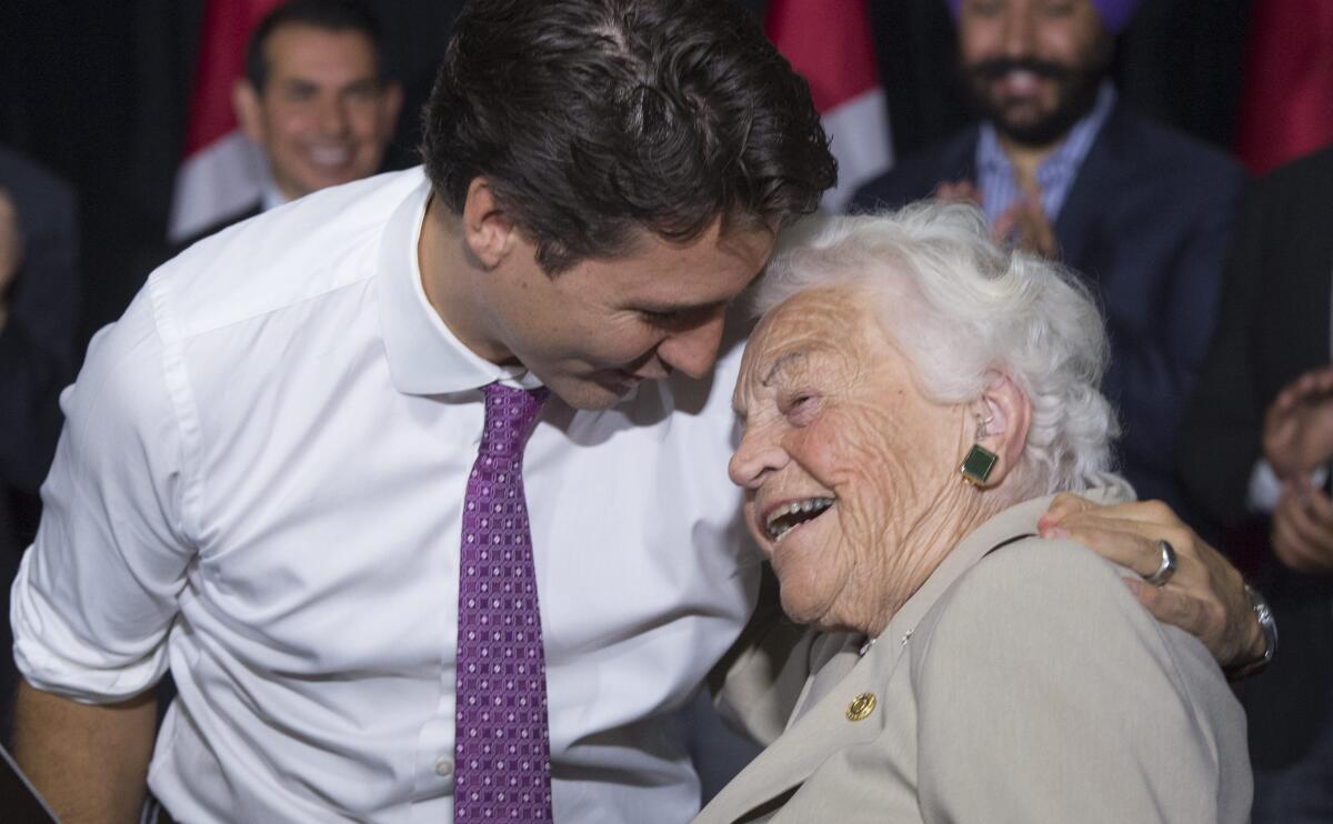 FILE - Liberal leader Justin Trudeau hugs former Mississauga mayor Hazel McCallion during a campaign event in a senior's home Friday, Oct. 16, 2015 in Mississauga, Ontario. McCallion, who led one of Canada’s largest cities into her 90′s, died Sunday morning, Jan. 29, 2023, leaving behind a legacy of feisty advocacy and more than three decades of nearly unchallenged leadership. She was 101. (Paul Chiasson/The Canadian Press via AP, File)