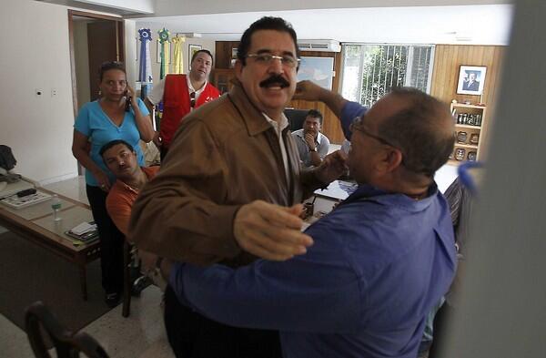 Honduras' ousted President Manuel Zelaya is greeted inside the Brazilian Embassy in Tegucigalpa. Zelaya returned to Honduras defying threats of arrest; his supporters rallied outside the mission.