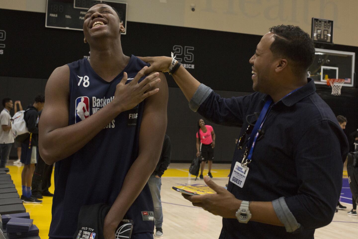 Charles Bassey, who was selected MVP of the global camp, is congratulated by his friend Joaquinne Arch.