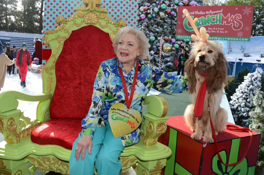 Actress Betty White poses with "Max," the Grinch's canine sidekick.