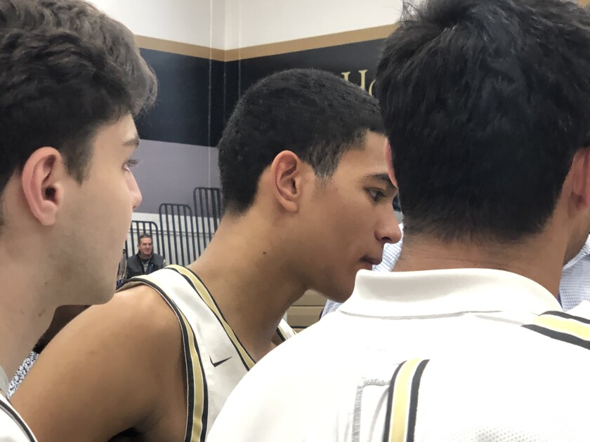 St. Francis' Andre Henry listens intently to talk from coach Todd Wolfson after scoring 25 points and making final two baskets in 49-46 win over Crespi in Mission League opener.