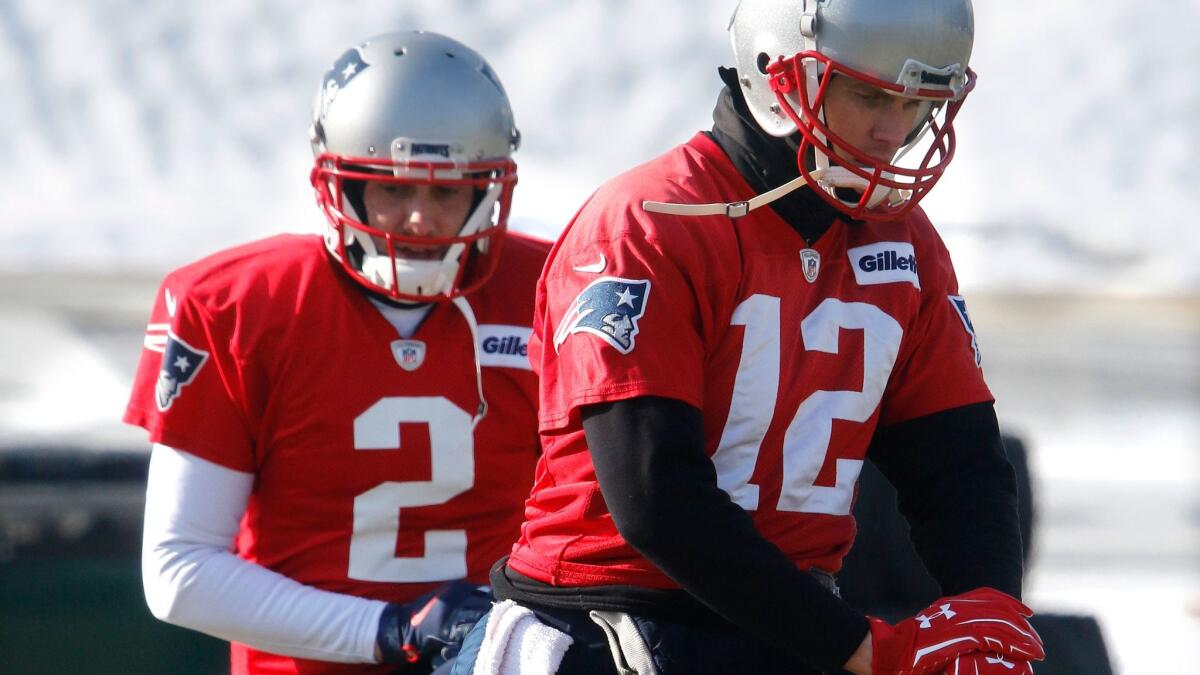New England Patriots quarterbacks Tom Brady (12) and Brian Hoyer (2) warm up during a practice on Friday. The Patriots host the Jacksonville Jaguars in the AFC championship game.