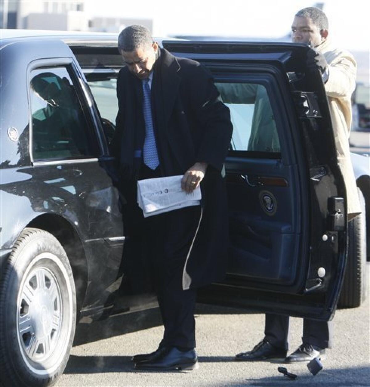 President-elect Barack Obama drops his BlackBerry as he steps out of his limousine before boarding a plane at Washington's Reagan National Airport, Friday, Jan. 16, 2009, prior to heading to Bedford, Ohio, where he will meet with workers at Cardinal Fasteners. (AP Photo/Charles Dharapak)