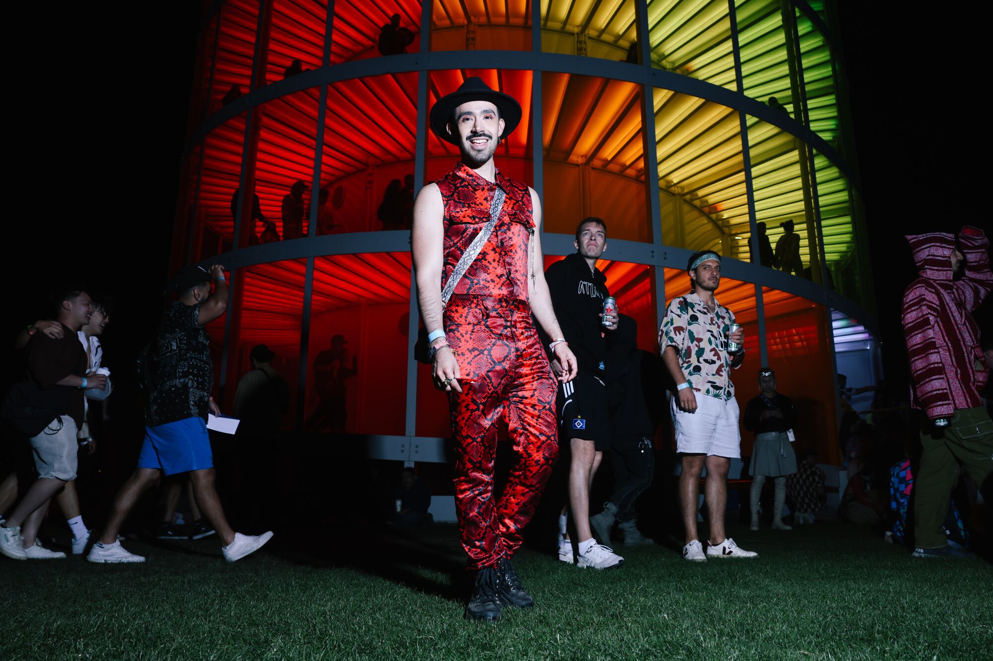 A Coachella attendee in a red snakeskin jumpsuit.