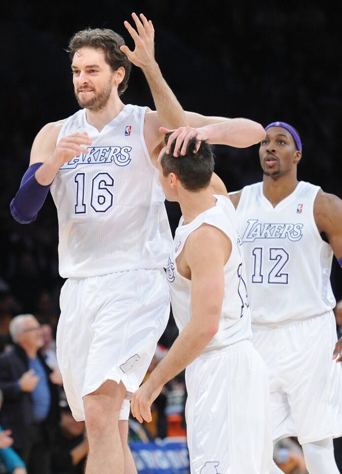 Lakers power forward Pau Gasol (16) celebrates with point guard Steve Nash after throwing down a dunk that helped seal a 100-94 victory over the Knicks on Tuesday at Staples Center.